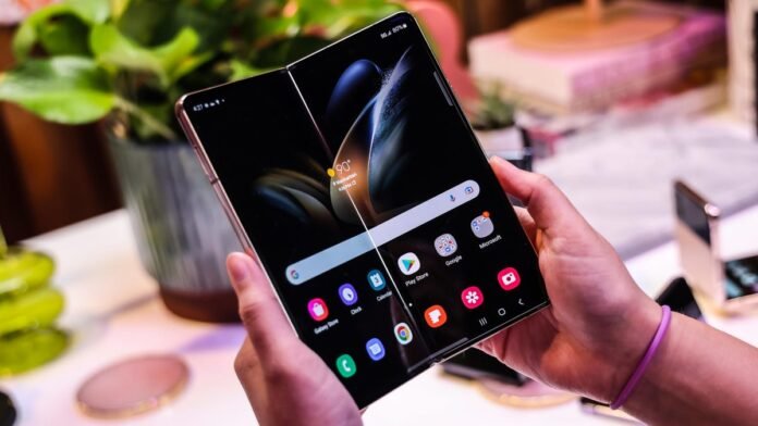 Samsung Galaxy Z Fold 4 Deals: $500 Off at Samsung, Samsung Galaxy Fold 4 slightly folded in the middle of the screen like a book