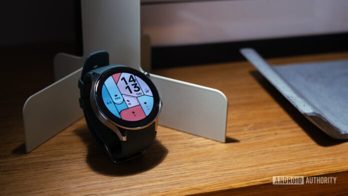 A great smartwatch, held back by Google's shortcomings OnePlus Watch 2 showing watch face on shelf