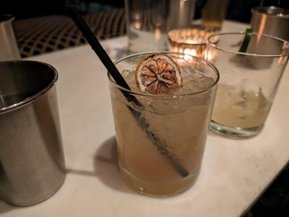 Google Pixel 8A Review: A Clear Choice Over the Pixel 8 16 A cocktail on a table in a dim bar.