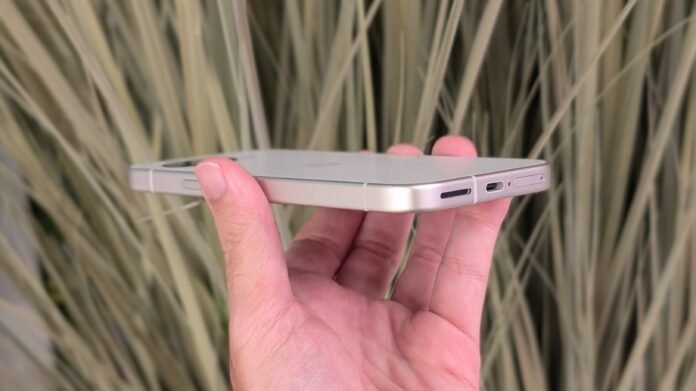 Google phones to get 'Battery health assistance' feature starting with The Porcelain Google Pixel 9a held flat in hand, the angle emphasizing the metal sides of the phone.