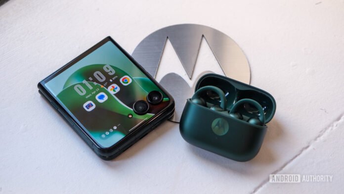 Motorola's Playlist Studio just ruined Spotify's algorithm for me Motorola Razr Ultra with earbuds on top of logo