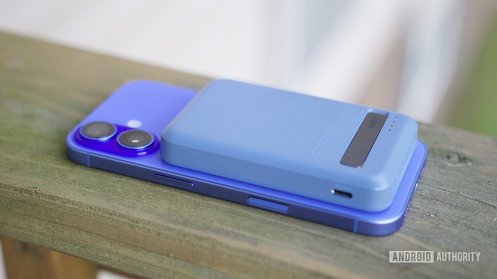 A Belkin power bank on top of an iPhone 16.