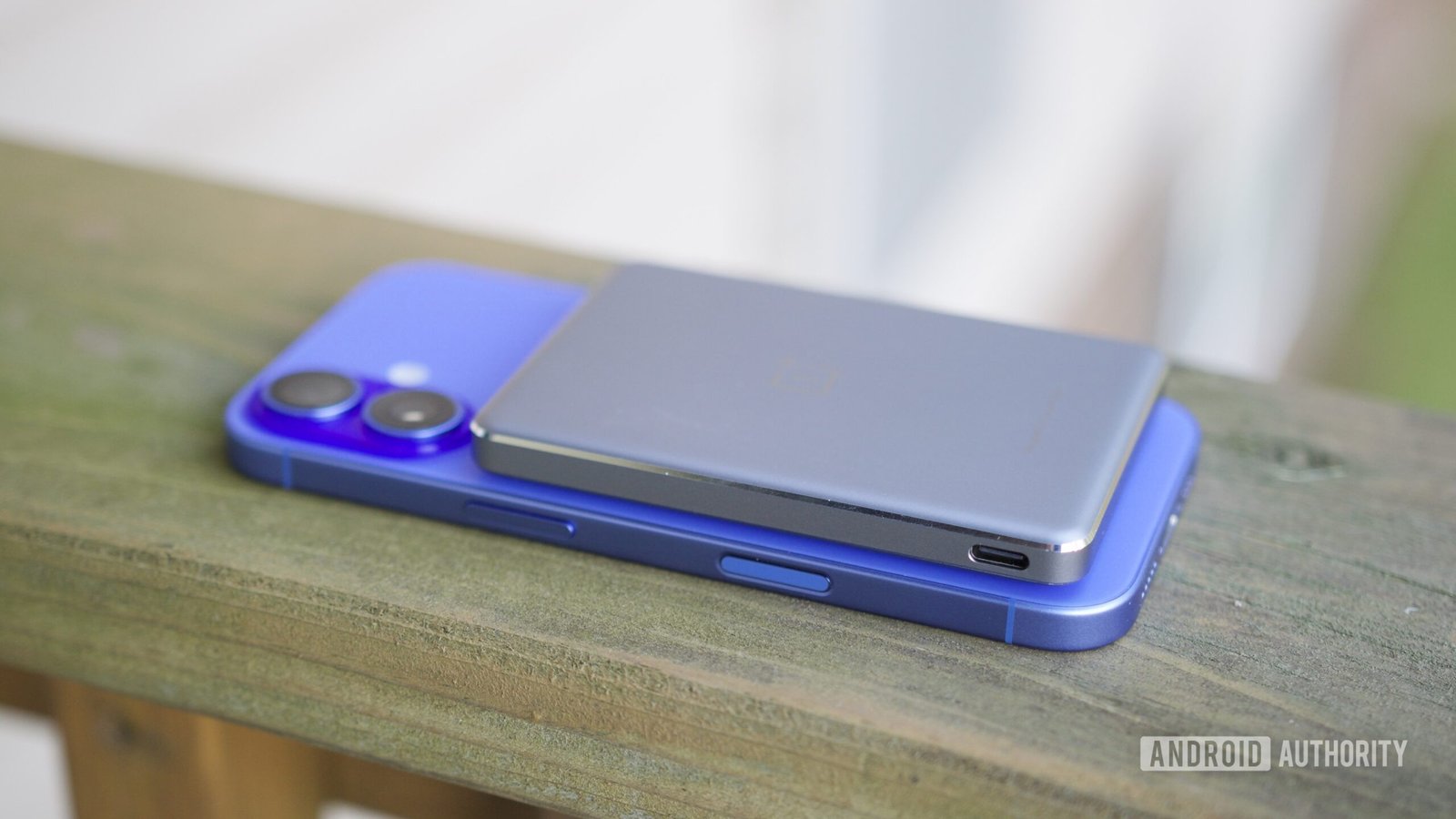 The OnePlus Slim Magnetic Power Bank on top of an iPhone 16.