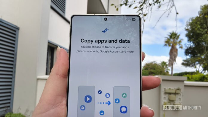 6 things I always do when setting up a new a smartphone held in a hand with a prompt to copy apps and data