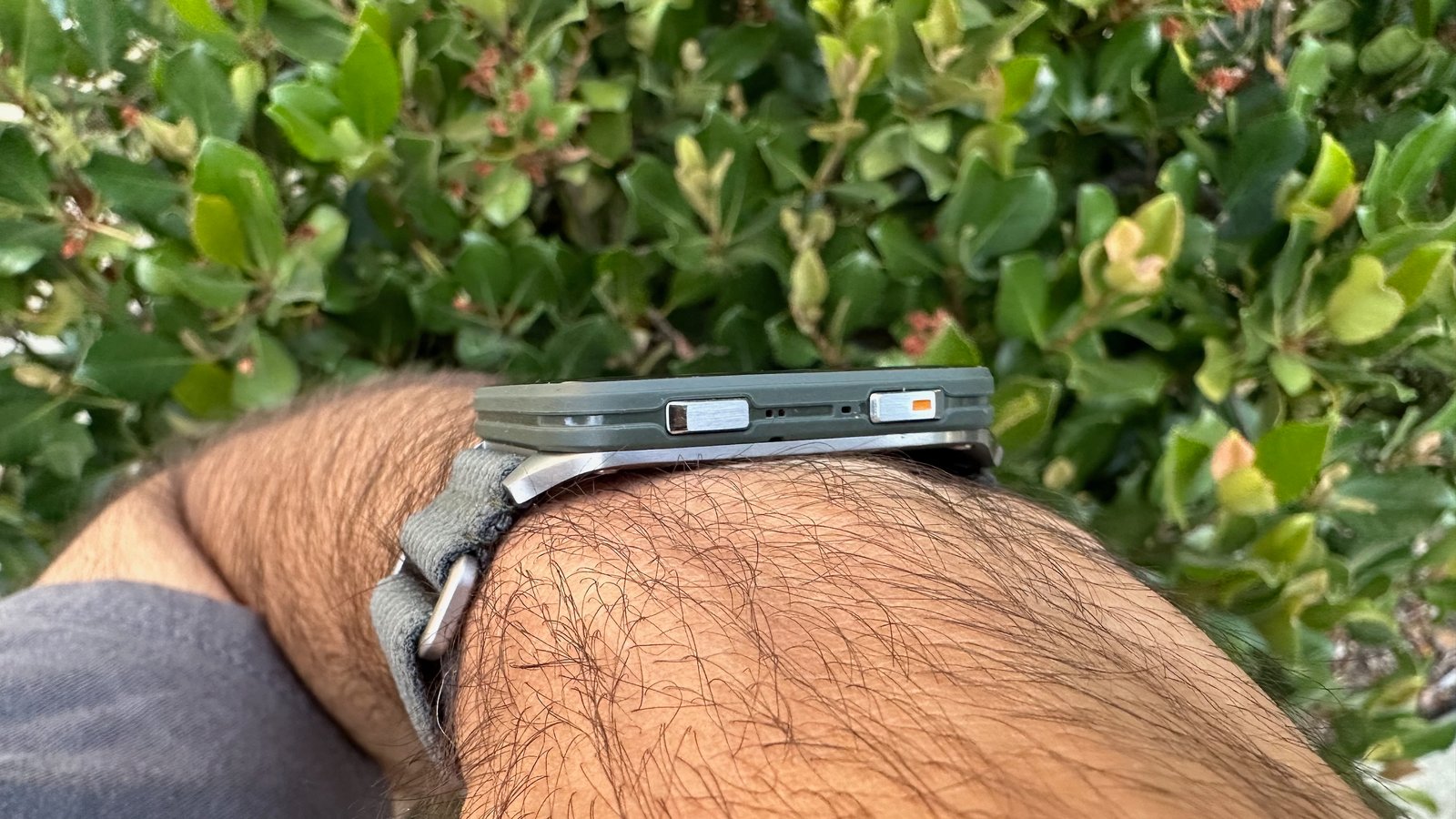 A side angle of the Garmin Venu X1 on the author's wrist, the photo angled to show the two side buttons.