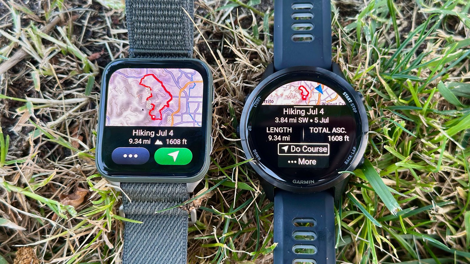 The Garmin Venu X1 (left) and Garmin Forerunner 970 (right) sitting aside each other on a lawn, both showing the same 9-mile hiking course, but the larger, square-shaped X1 display shows much more map info.