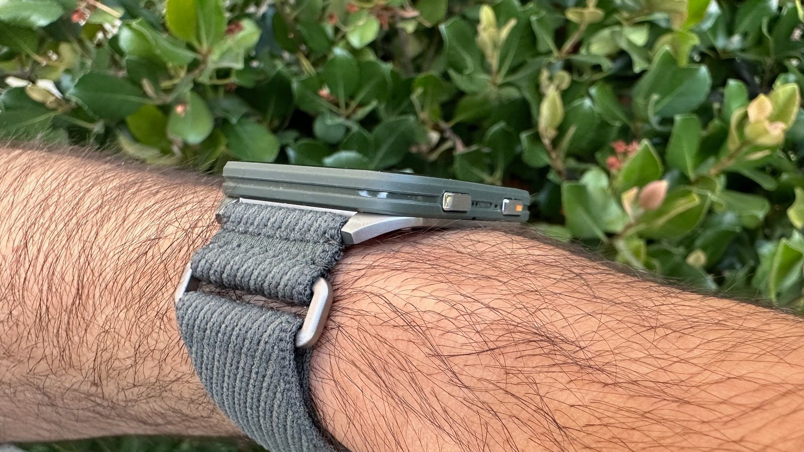 A side view of the Garmin Venu X1 on a wrist showing its 8mm thickness.