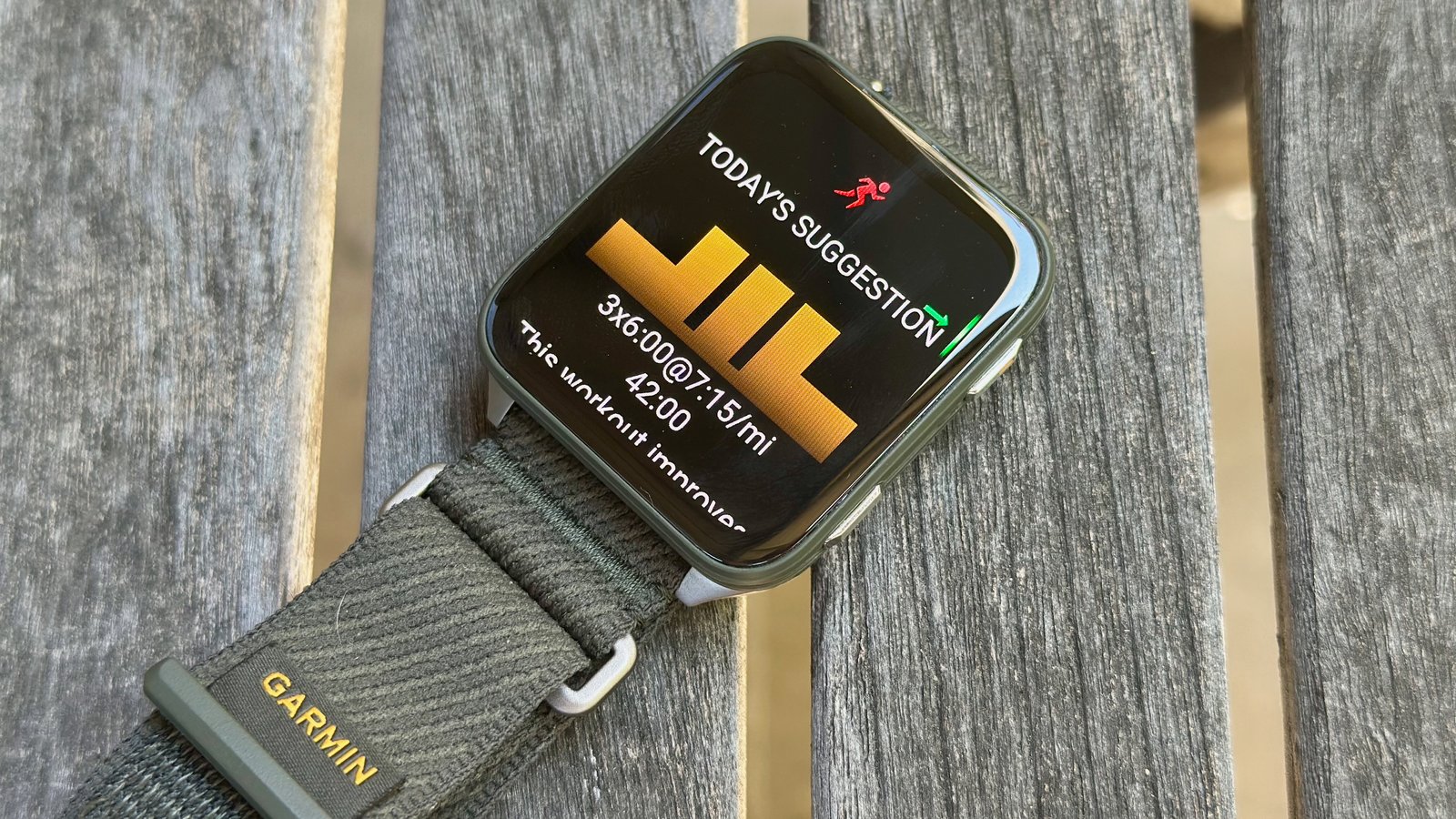 The Garmin Venu X1 sitting on a table, with the daily suggested workout visible.