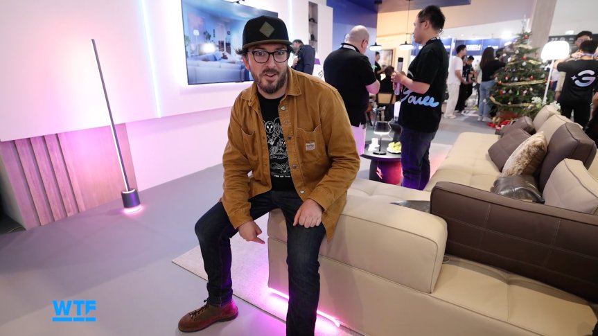 I Went Shopping for My Ultimate Smart Home of the Future at IFA 2026 2 The writer sitting on a couch that has lighting on the underside at IFA.