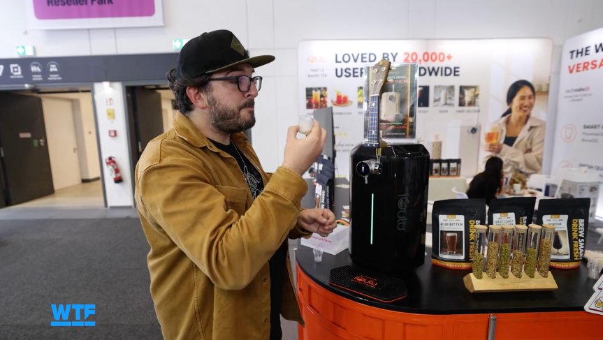 I Went Shopping for My Ultimate Smart Home of the Future at IFA 2026 3 The writer drinking a very small sample of freshly made beer at IFA.