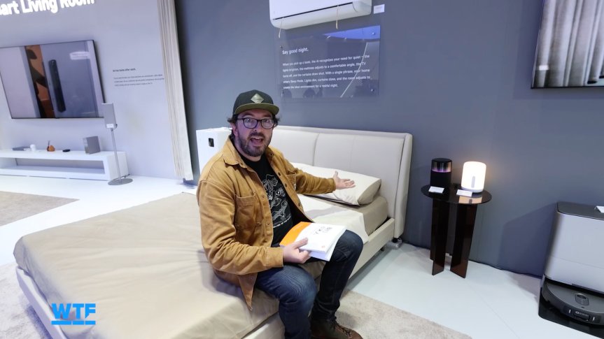 I Went Shopping for My Ultimate Smart Home of the Future at IFA 2026 5 The writer looking confused at a water bottle that has come out of an extremely cold fridge showcased at IFA.