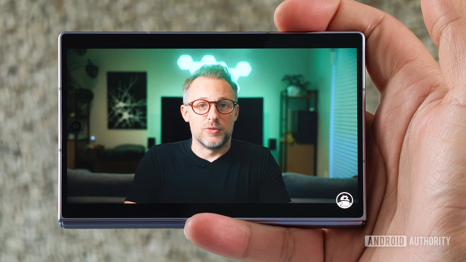 Samsung Galaxy Z Fold in hand video playing on cover screen
