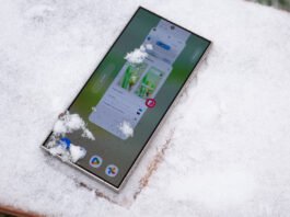 A Samsung Galaxy S24 Ultra with snow on its display